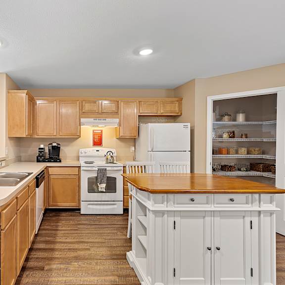 a kitchen with wooden cabinets and a white refrigerator.