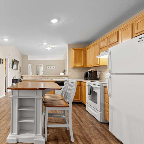 a kitchen with wooden cabinets and a white refrigerator.