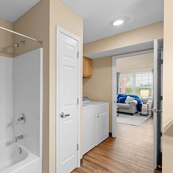 a bathroom with a white tub and shower curtain.