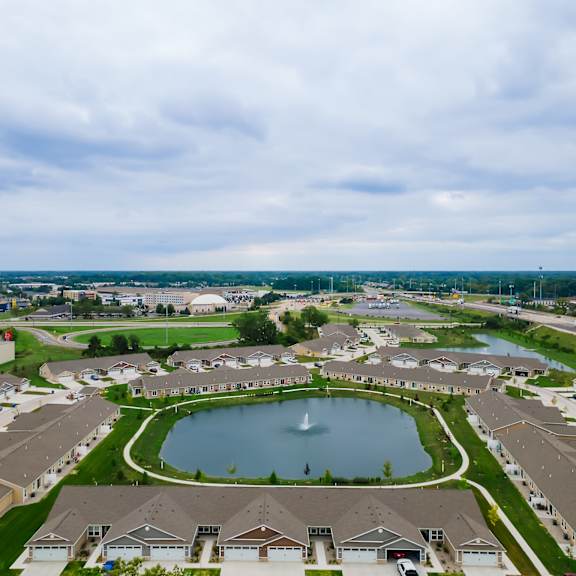 a bird's eye view of a residential area with a lake and houses.