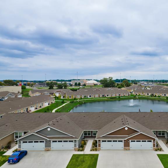 a suburban neighborhood with houses and a pond.