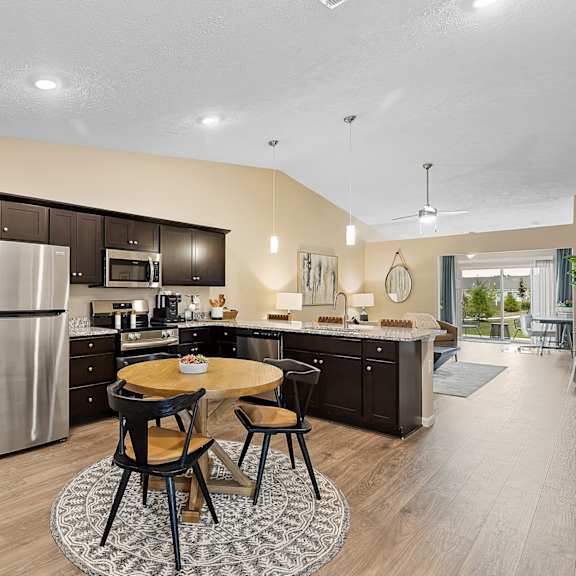 a modern kitchen with a dining table and chairs.