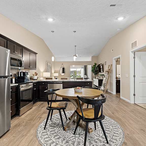 a kitchen with a table and chairs in the middle of the room.