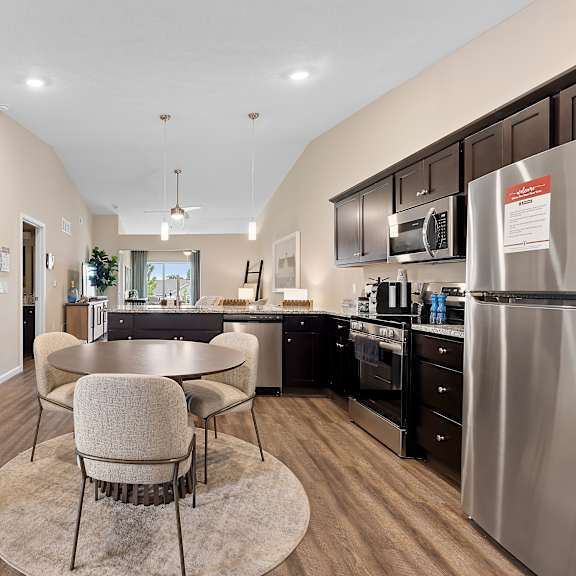 a kitchen with a table and chairs in the middle of the room.