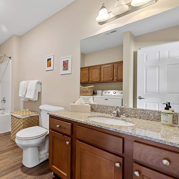 a bathroom with a toilet, sink, and bathtub.