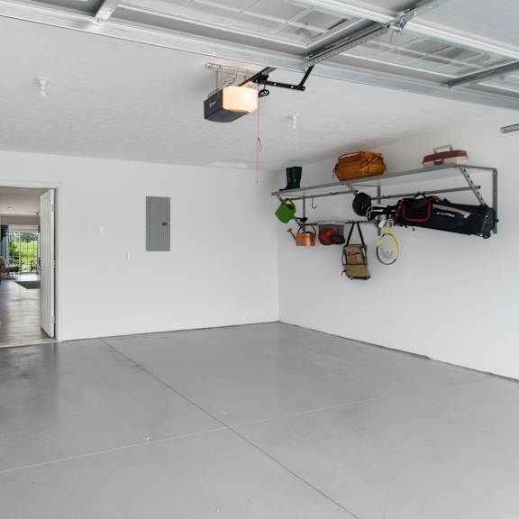 a room with a white wall and a grey floor.