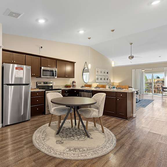 a kitchen with a table and chairs in the middle of the room.