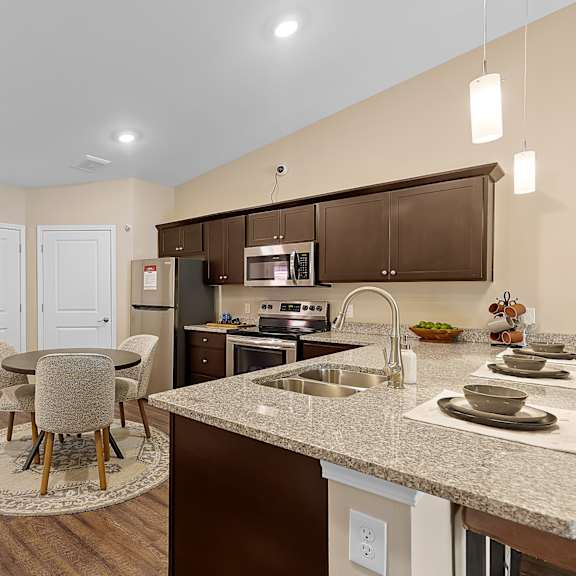 a kitchen with brown cabinets and a white countertop.