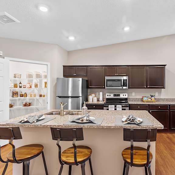 a kitchen with a table and chairs.