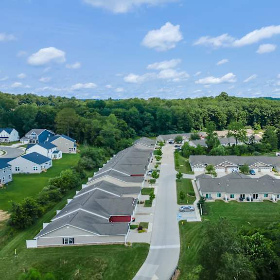 a bird's eye view of a residential area with houses and a road.