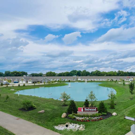 a beautiful aerial view of a community with a large swimming pool and a sign that reads "redwood".