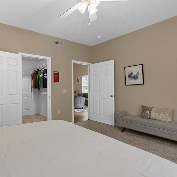 a bedroom with a large bed and a ceiling fan.
