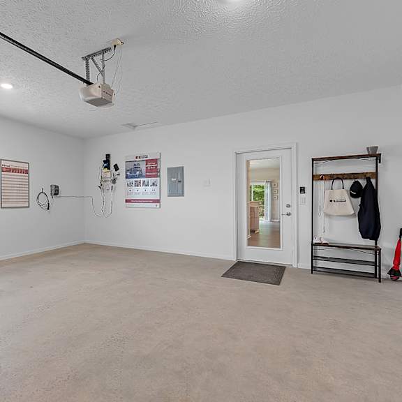 a room with a white ceiling and a window with blinds.
