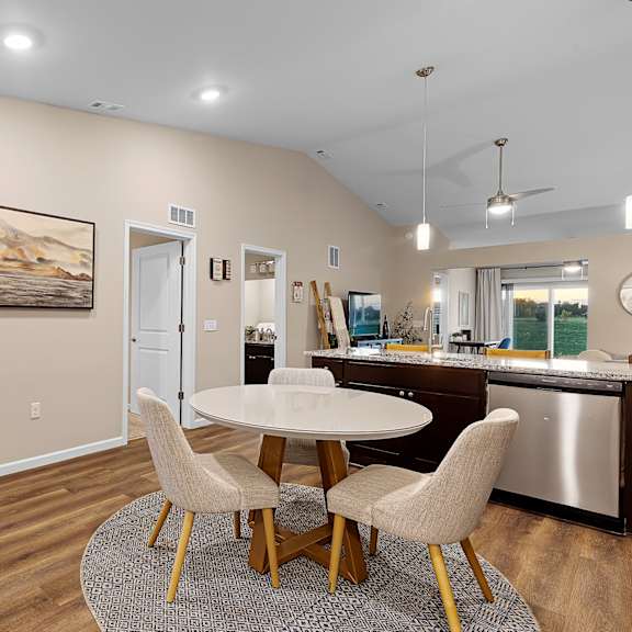 a dining room with a white table and chairs.