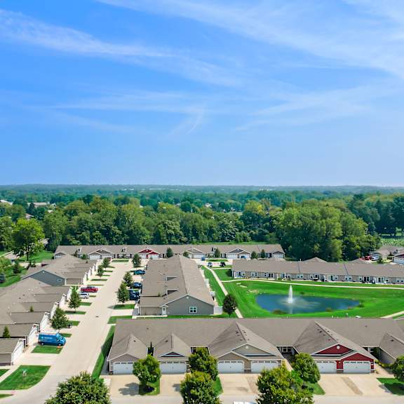 a suburban neighborhood with houses and a pond.