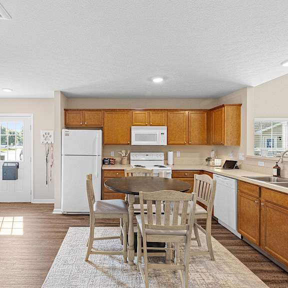 a kitchen with wooden cabinets and a white refrigerator.