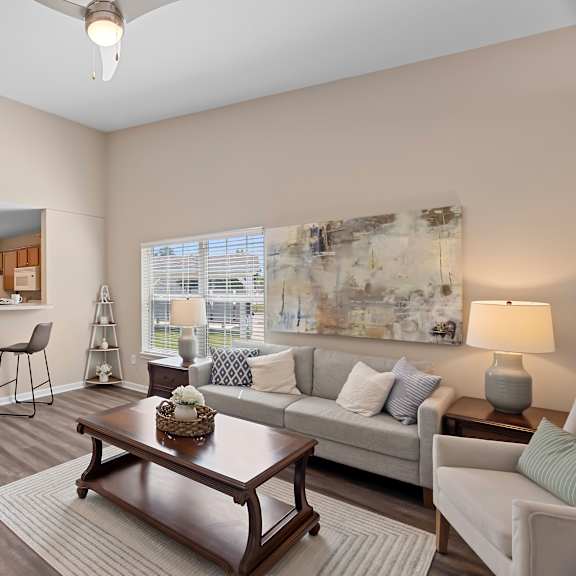 a living room with a brown coffee table and a white couch.