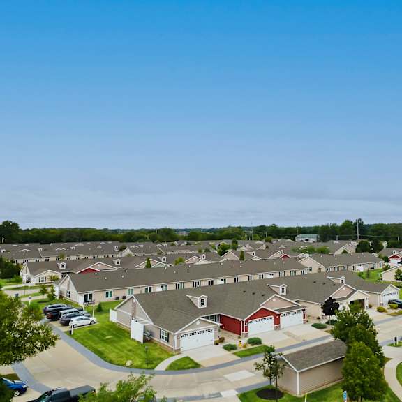 a suburban neighborhood with houses and cars.