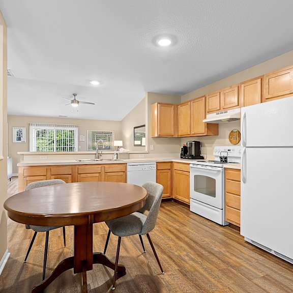 a kitchen with a table and chairs in the middle of the room.
