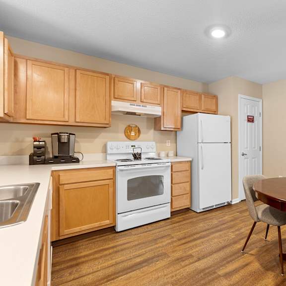 a kitchen with wooden cabinets and a white refrigerator.