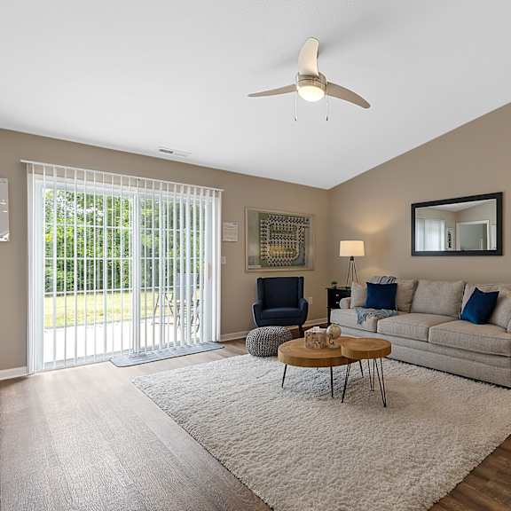 a living room with a brown chair and a white couch.