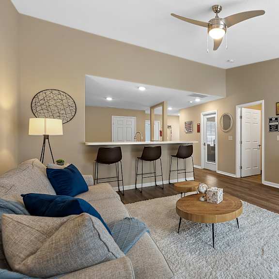 a living room with a grey couch and a wooden coffee table.