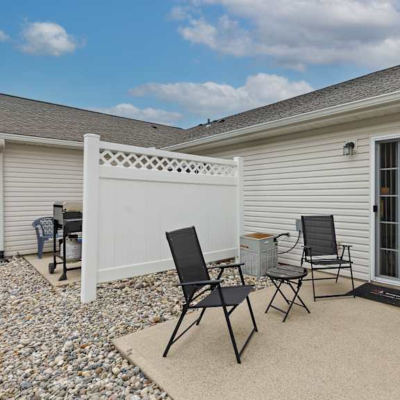 a patio with two chairs and a table.