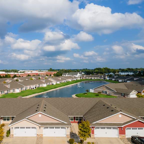 a suburban neighborhood with houses and a pool.
