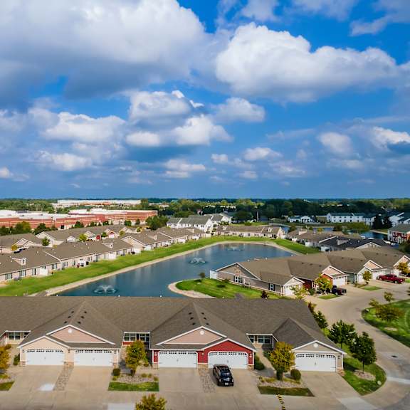 a suburban neighborhood with houses and a pond.