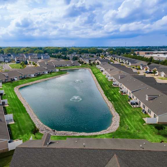 a residential area with a lake in the middle.