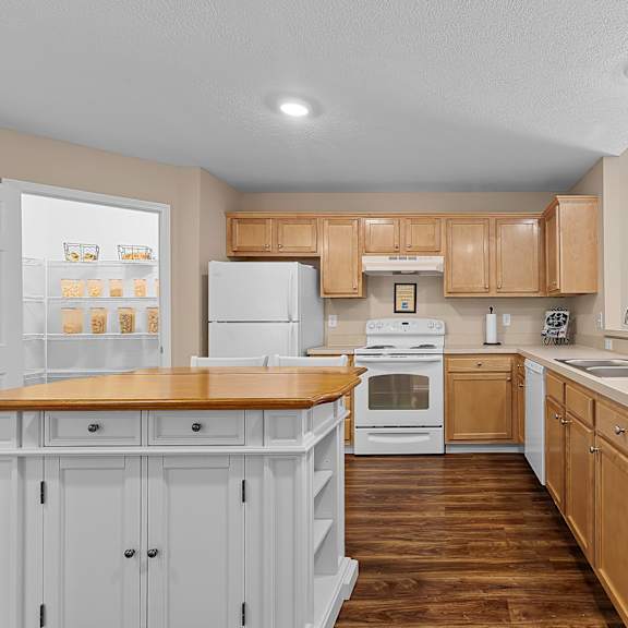 a kitchen with wooden cabinets and a white refrigerator.