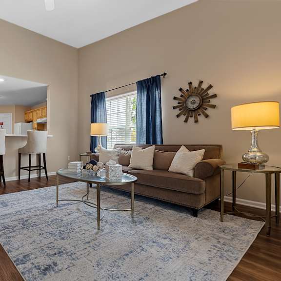 a living room with a couch, chairs, and a coffee table.