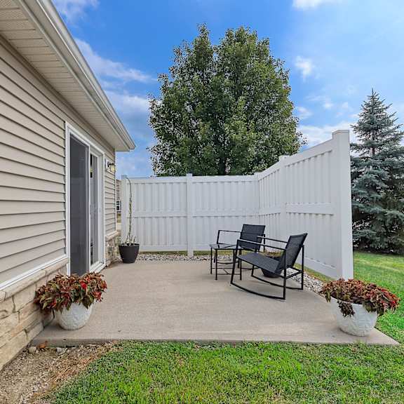 a small patio with a table and chairs.