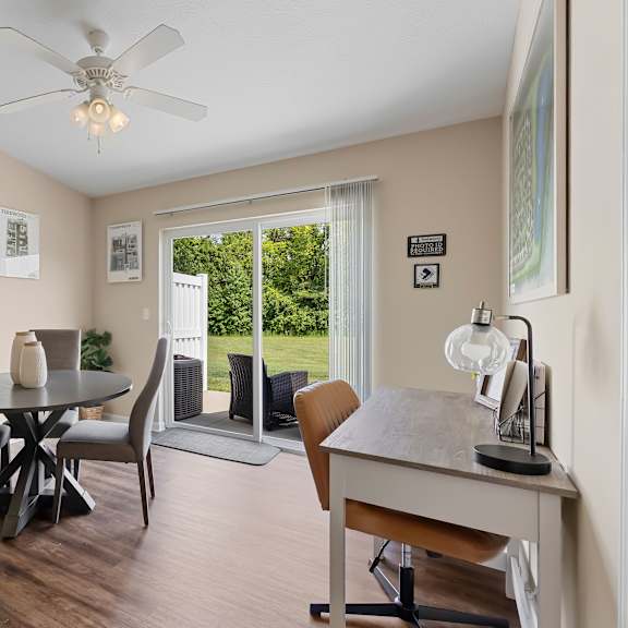 a dining room with a table and chairs.