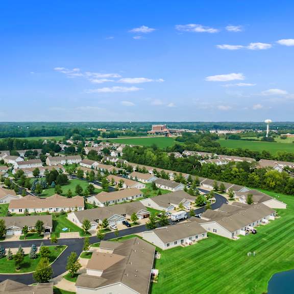 a suburban neighborhood with houses and a large open field.
