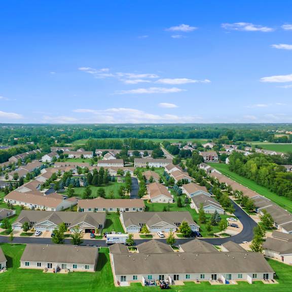 a bird's eye view of a residential neighborhood with houses and green lawns.