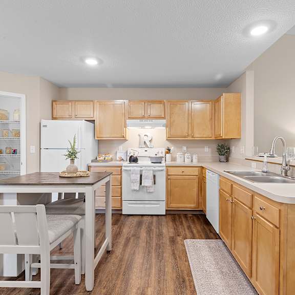 a kitchen with wooden cabinets and a white refrigerator.