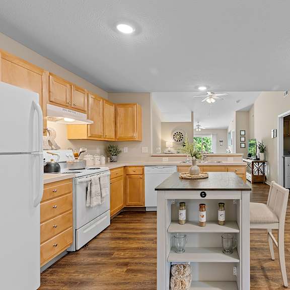 a kitchen with wooden cabinets and a white refrigerator.