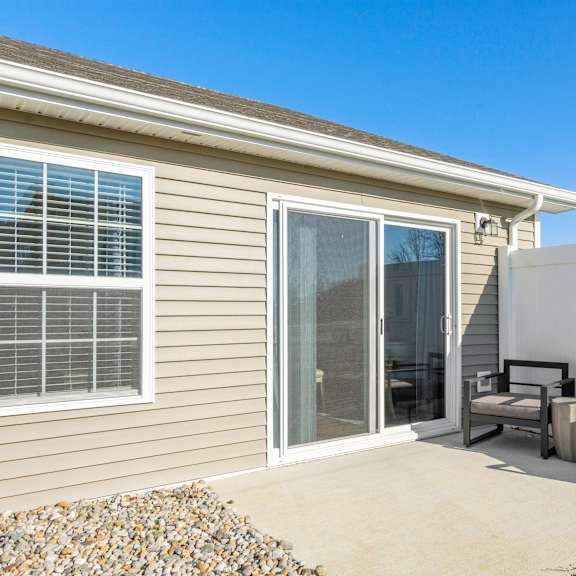 a house with a patio and a white fence.