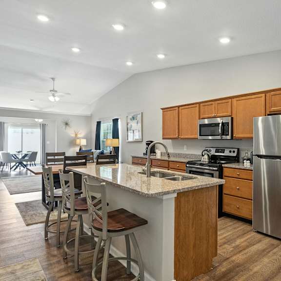 a kitchen with a refrigerator, microwave, and oven.