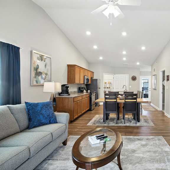 a modern living room with a grey sofa and a coffee table.