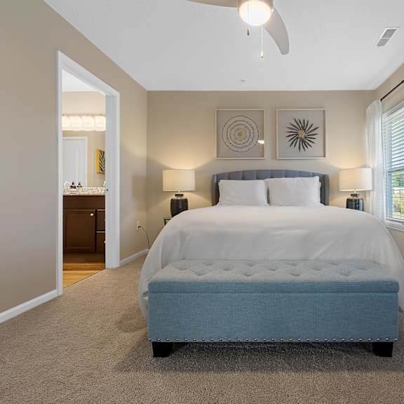 a bedroom with a large bed and a ceiling fan.