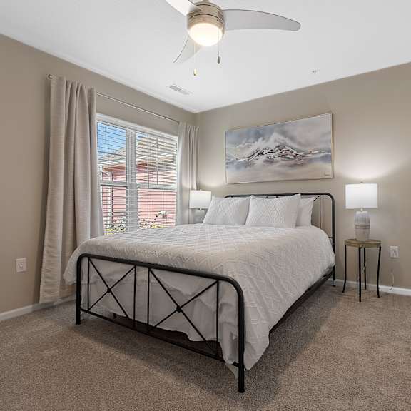 a bedroom with a large bed and a ceiling fan.