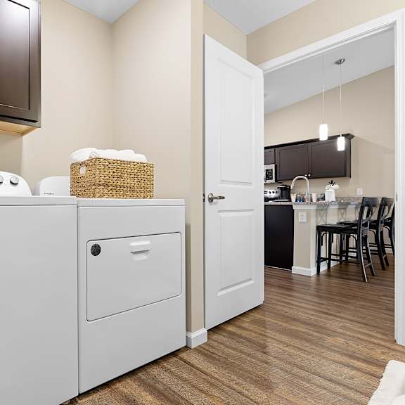a white refrigerator is in a kitchen with brown cabinets.