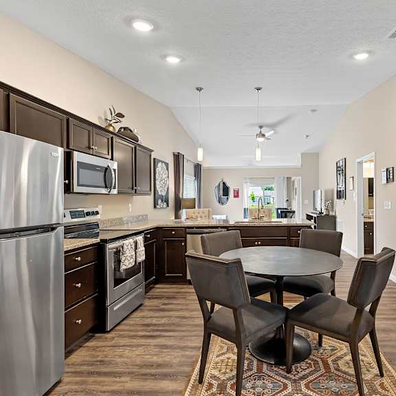 a kitchen with a table and chairs in the middle of the room.