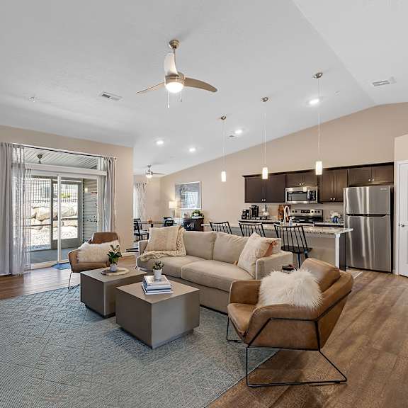 a modern living room with a brown sofa and a wooden coffee table.