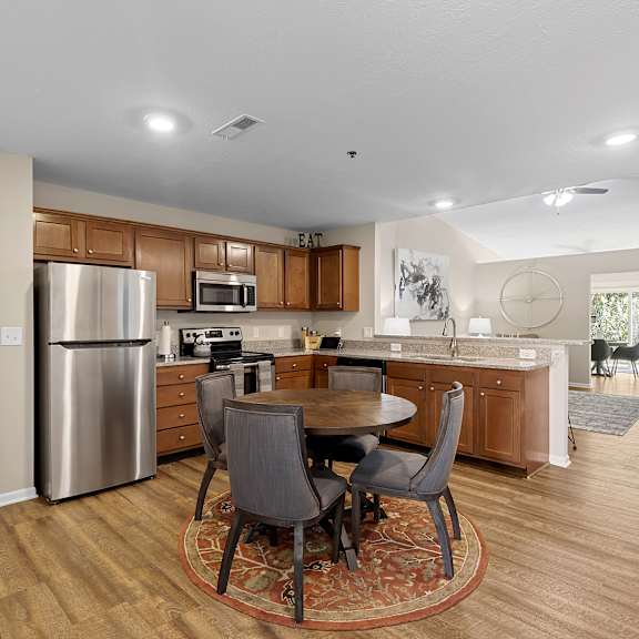 a kitchen with a table and chairs in the middle of the room.