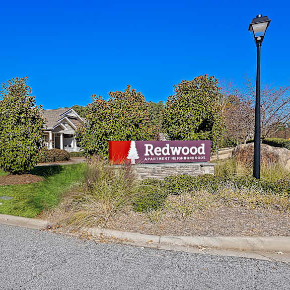 a sign for redwood is in front of a house.