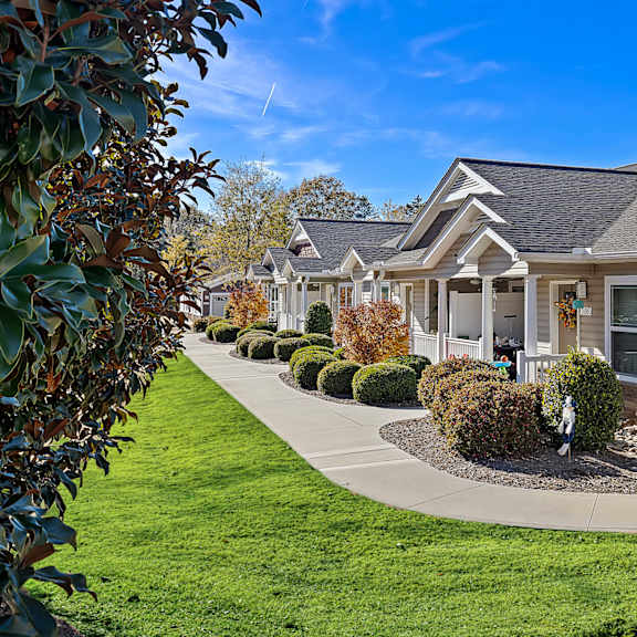 a row of houses with a green lawn in front.