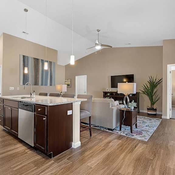 a modern kitchen with a wooden floor and a large island.